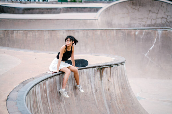 Portrait of Asian Chinese girl with skate in skatepark