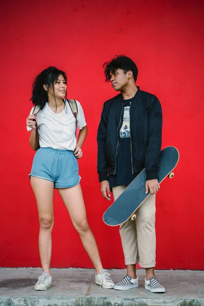 Stylish Young Couple Standing Red Background Skateboard Full Length — Stock Photo, Image