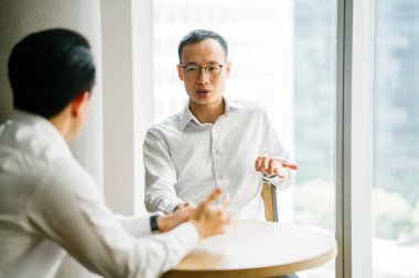 modern ofis masada oturan ve birlikte çalışan iş adamları