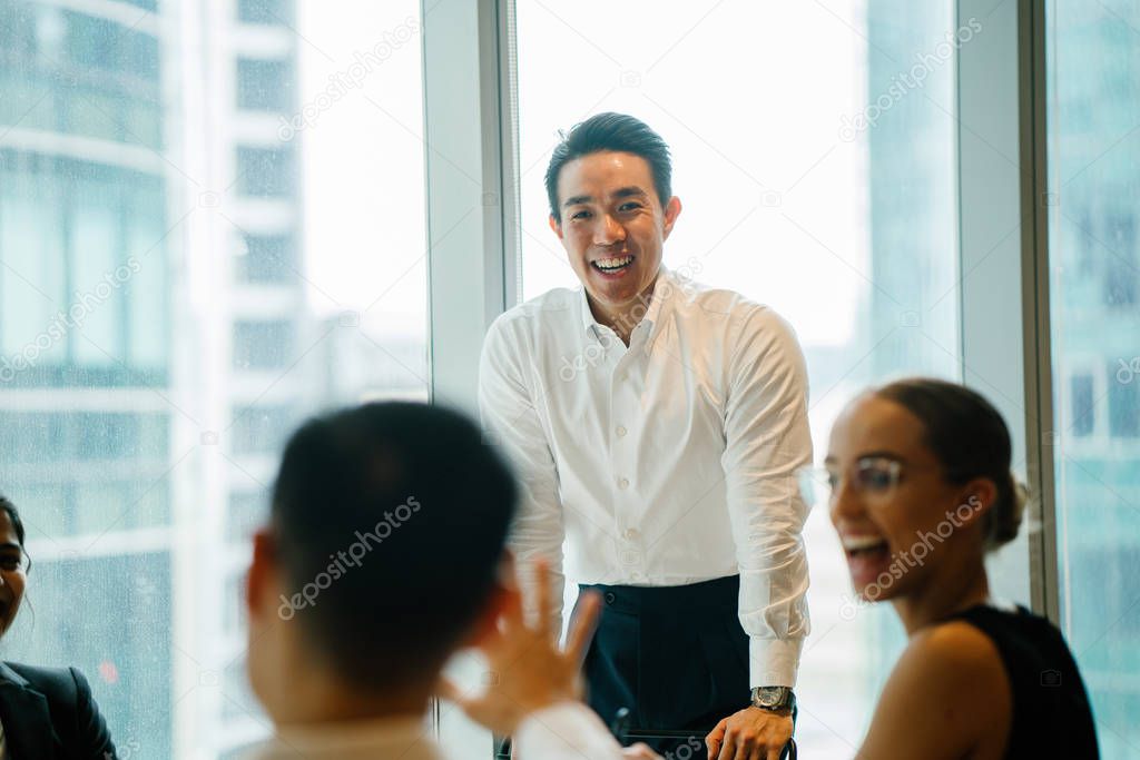 business people discussing project using laptop standing in modern office 