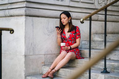 kahve adımlar ile telefonda kırmızı elbiseli Genç kadın