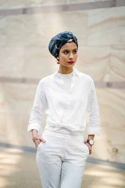 Portrait of a young Muslim woman wearing a turban (headscarf, hijab). She is elegant and  attractive