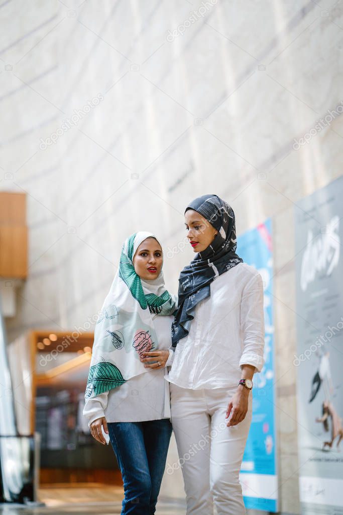 Two young and attractive Muslim women in head scarves 