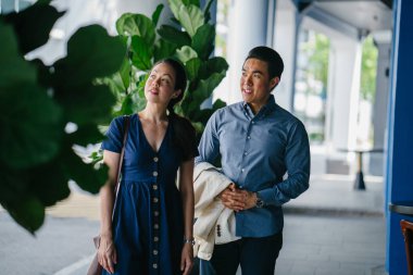 Bir Asya Çin portresi çift bir tarihte, hafta sonu. Genç, yakışıklı ve iyi giyimli adam ve kadın bir şık yazlık elbise giyiyor. 