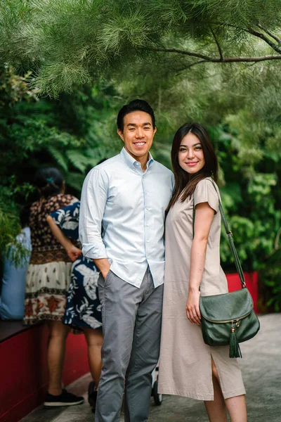 Portrait of young happy asian couple posing