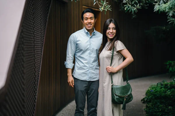 Portrait of young happy asian couple posing