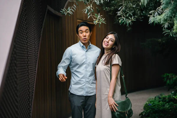 Portrait of young happy asian couple posing