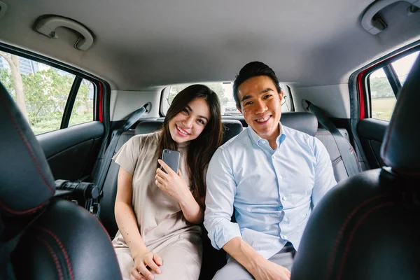 Beautiful young asian couple in car