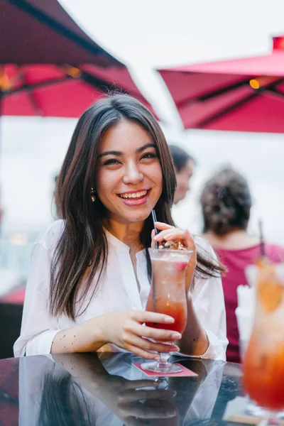 stock image young attractive woman drinking cocktail in outdoor cafe 