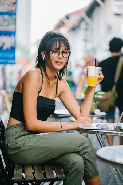 Молодая Азиатская Женщина Ноутбуком Питьевой Апельсиновый Сок Открытом Кафе — стоковое фото