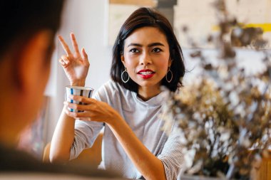 Genç bir sabah kahvelerini birlikte sabah işe gitmeden zevk Malay evli. Bir başkasına konuşuyorlar 