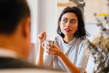 Genç bir sabah kahvelerini birlikte sabah işe gitmeden zevk Malay evli. Bir başkasına konuşuyorlar 