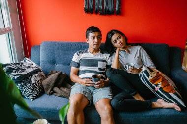 evli Malay çift birlikte modaya uygun ve modern oturma odasında onların kanepede oturup