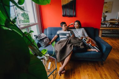 evli Malay çift birlikte modaya uygun ve modern oturma odasında onların kanepede oturup