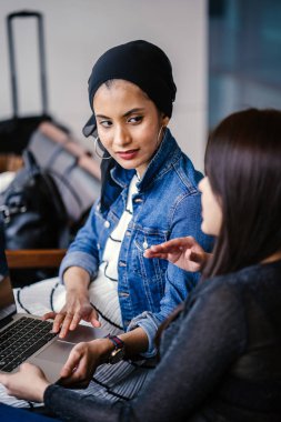 Müslüman bir Orta Doğulu kadın Çinli bir meslektaşıyla iş görüşmesi yapıyor..
