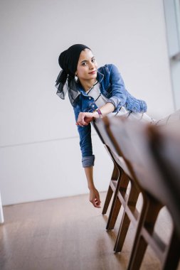 Genç, zarif ve çekici Malezyalı Müslüman kadın gün boyunca elbise ve kot ceket giyiyor..