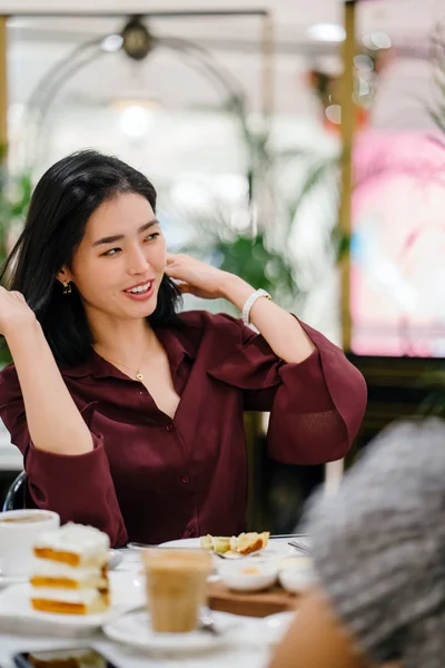 一个美丽而优雅的年轻的韩国亚洲妇女坐在一个优雅的室内咖啡馆的肖像 — 图库照片