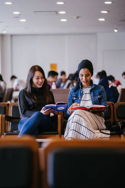 Dos Jóvenes Amigas Sentadas Banco Leyendo Libros Discutiendo Una Una —  Fotos de Stock