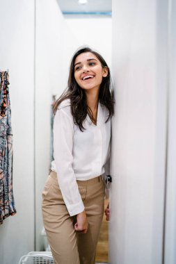 Yeni giyim moda salonu bir alışveriş merkezinde bir montaj odasında çalışıyor bir genç ve güzel Hint Asyalı kadın portresi.