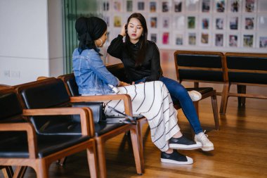 İki bayan arkadaş bankta oturup sohbet ediyorlar. Biri Çinli, diğeri Müslüman.