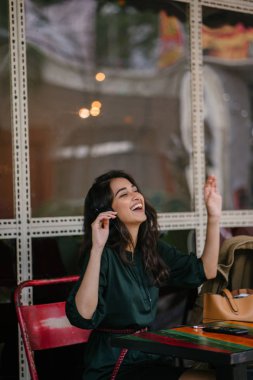 Genç Hintli Asyalı kadın o onun Smartphone-e doğru onun kulaklık streaming müzik hoşlanır