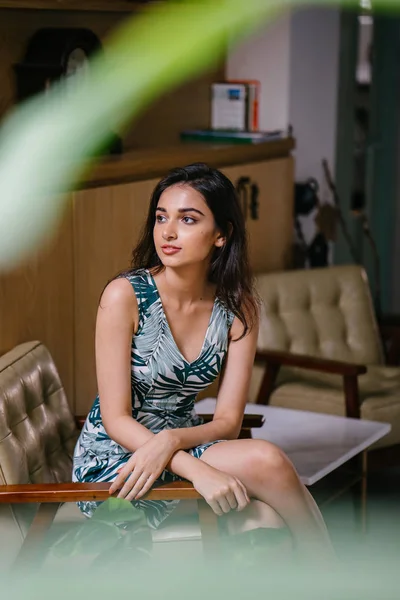 Portrait of a young, attractive and confident Indian Asian woman in a dress