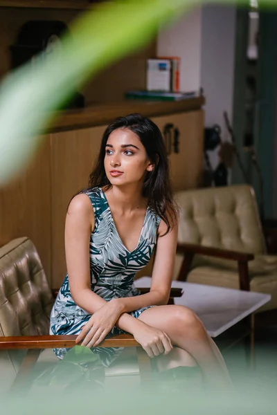 Portrait of a young, attractive and confident Indian Asian woman in a dress
