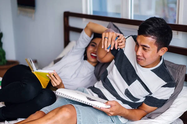Portrait Of A Young And Attractive Malay Asian Couple Sitting Around Lazily In Bed On The Weekend Happy Engaged Stock Photo 211949724