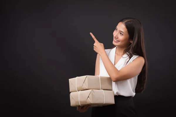 woman holding parcel box, pointing up