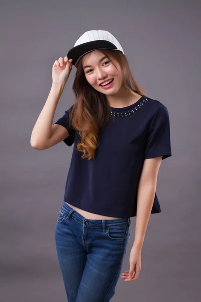 happy asian girl with smiling woman face; portrait of happy, smiling, joyful, cheerful asian woman in casual dress studio isolated; asian chinese young adult woman model