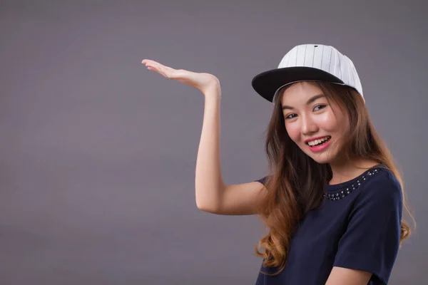 confident girl, happy woman pointing up gesture; portrait of confident happy successful asian woman pointing finger at you; showing, advertising, focusing point concept; asian young adult woman mode