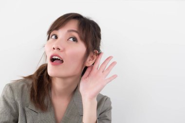 Asyalı kadın işitme veya dinleme; söylenti, dedikodu, dedikodu, iyi ya da kötü haber için dinleme kadın portre; iletişim, bilgi, söylenti kavramı; Asyalı Çinli kadın genç yetişkin modeli
