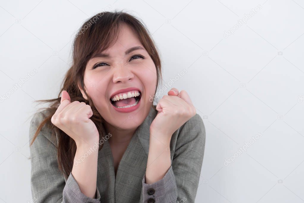 excited woman shouting, screaming with surprise and interest; portrait of surprised excited asian woman with exciting, oh, uh, ah, wow interesting expression; asian adult woman model
