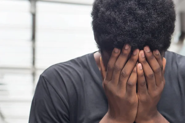 african man with face palm gesture stress or depression; portrait of depressed face palm african man or black man suffers from headache, stress, depression, failure concept; adult african man model
