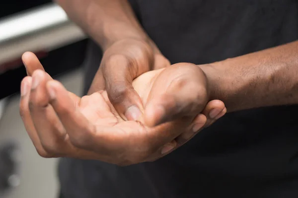 african man suffering from wrist or hand pain; sick black man with cps wrist pain, trigger finger, bone arthritis, gout symptoms; sickness, health care or pain concept; adult african man model