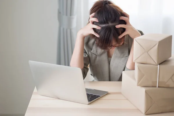 asian woman business owner working with stress and headache; portrait of sad stress unhappy business woman getting headache from business failure, loss, problem; adult asian chinese woman model