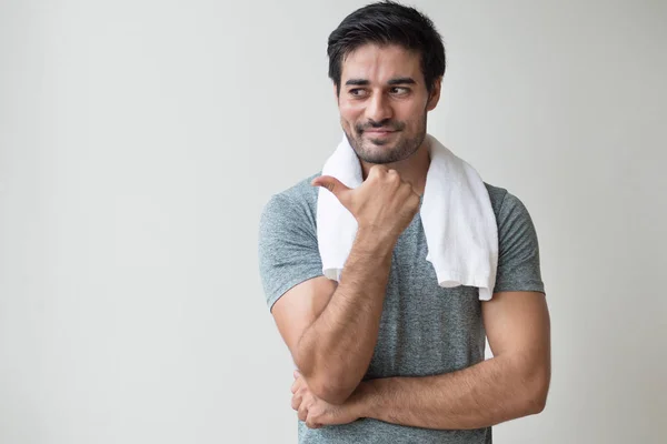 confident fitness man pointing thumb up gesture; portrait of happy, healthy, confident indian man training, working out in fitness gym; asian north indian adult man model