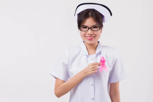 女护士手拿着粉红色丝带弓 乳腺癌意识符号 乳腺癌日 粉红色丝带为医疗 护士慈善基金筹集概念为乳腺癌患者或预防 — 图库照片