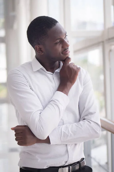 Thoughtful African man thinking; portrait of pensive young adult african man thinking or planning; good idea, future, brain storming concept; African young adult black man model