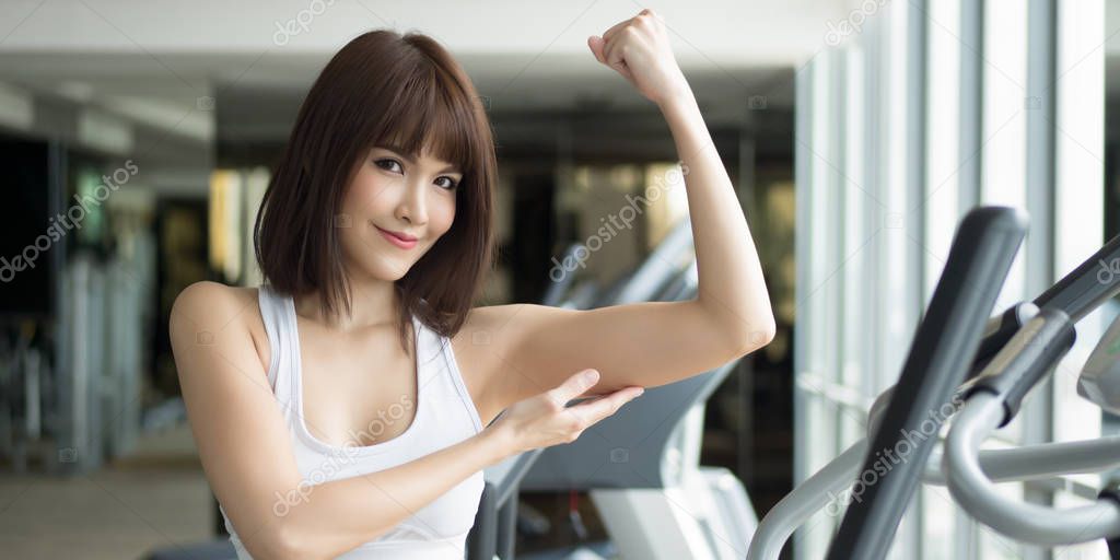 healthy strong fitness woman works out in gym. portrait of fitness woman in gym posing for strong body and arm, gym workout, weight training, healthy lifestyle concept. panorama banner crop format