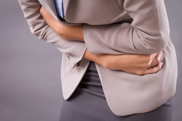 胃の痛みや月経を持つ女性腹痛 月経けいれん 食中毒 胃酸の逆流に苦しむ病気の女性アジアの若い大人 日焼け肌の女性モデル — ストック写真