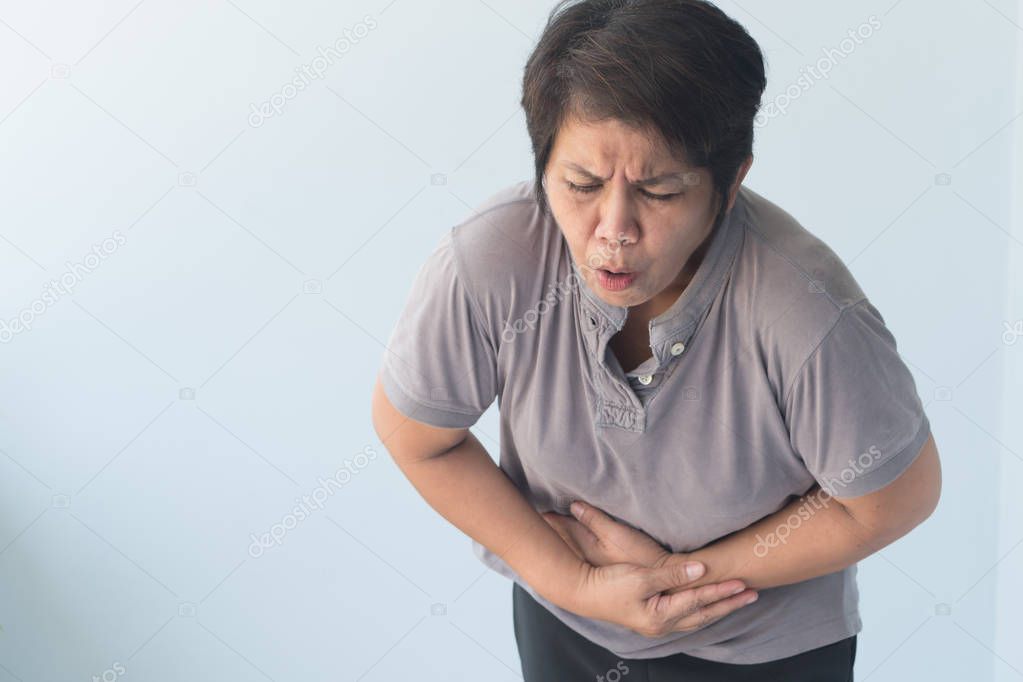 sick old senior woman suffering from stomachache, diarrhea, constipation, food poisoning