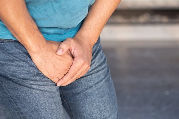Sick man holding his genitalia; concept of pee holding, lack of toilet, prostate cancer, UTI or urinary tract infection — Stock Image Sick Man Holding His Genitalia Concept Pee Holding Lack Toilet Stock Image