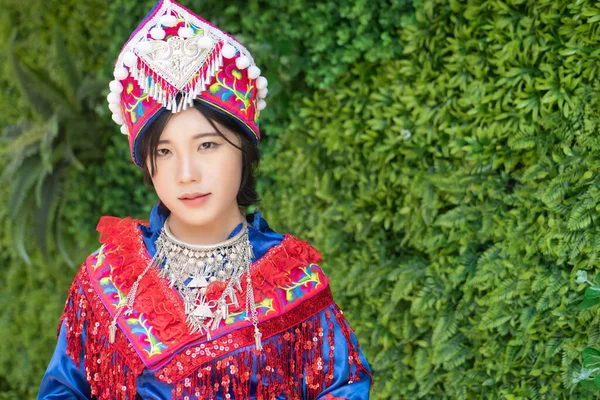 portrait of Hmong young woman in tradition Hmong costume for young girl; Asian ethnic tribal people in traditional colorful clothing culture of Hmong or Miao people in east Asia and southeast Asia