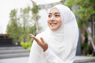 happy muslim woman pointing up clipart