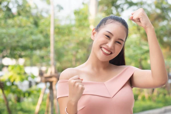 strong winning excited southeast asian woman face expression; portrait of strong successful positive excited happy smiling asian woman with successful exciting guts pose; asian adult woman model