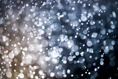 Bokeh 'te noel arkaplanı deseni soyut ışık parıldayan yıldızlar. simli klasik ışık arkaplanı