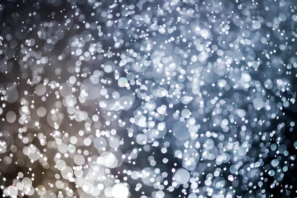 Bokeh 'te noel arkaplanı deseni soyut ışık parıldayan yıldızlar. simli klasik ışık arkaplanı