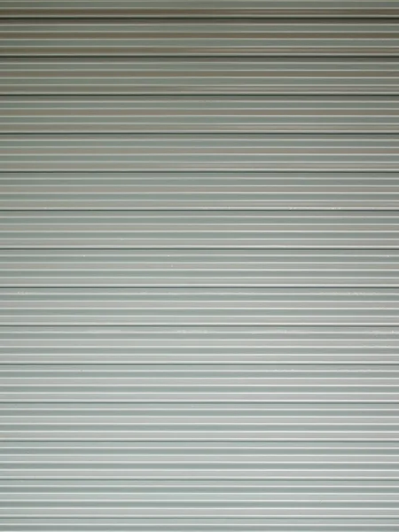 段ボールの金属板 白いスライド扉 ローラー シャッター テクスチャ — ストック写真