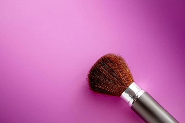 Makeup brush on Pink Pastel paper texture background. Pastel color , Minimal and Valentine concept. Copy space